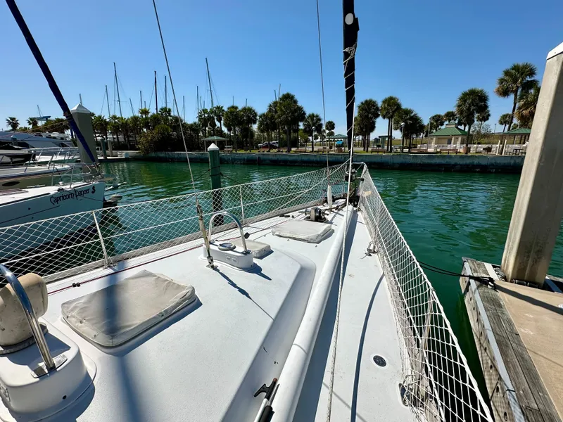 Slide: The Image of Concordia 52 sailboat docked in a marina, 1989 model, sunny day, clear water. - 27