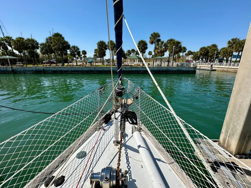 Slide: The Image of Bow of 1989 Concordia 52 sailboat docked in a marina with palm trees. - 28