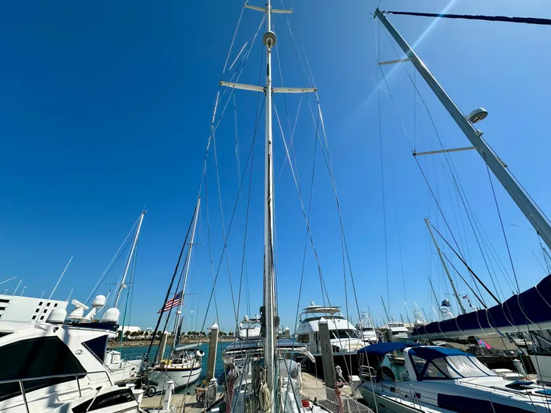 Slide: The Image of Concordia 52 sailboat from 1989 docked at a marina under a clear blue sky. - 30
