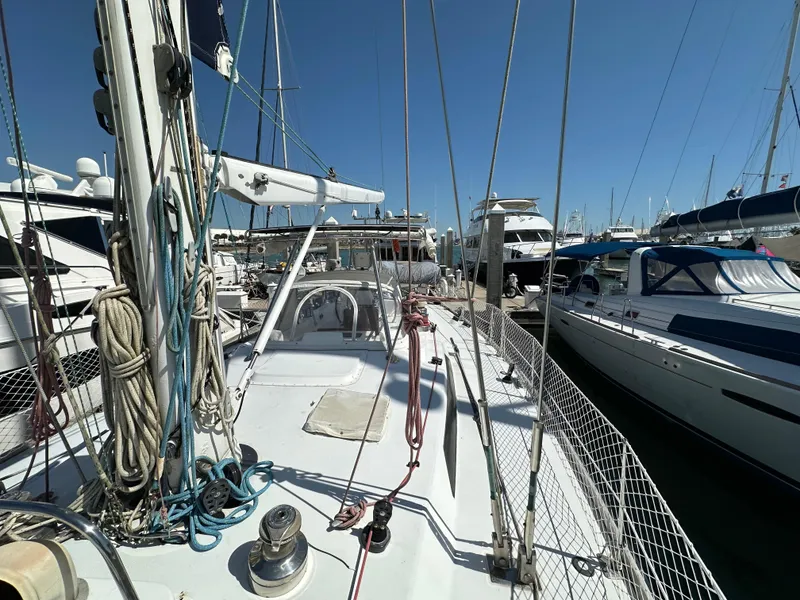 Slide: The Image of 1989 Concordia 52 sailboat docked at a marina, surrounded by other boats. - 32