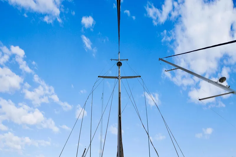 Slide: The Image of Sailboat mast against blue sky with clouds, Concordia 52, 1989 model. - 5