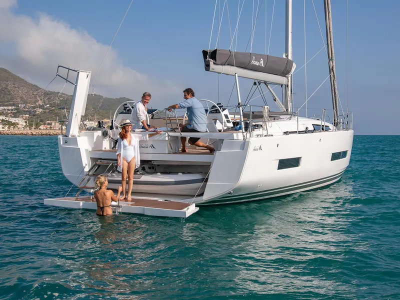 Slide: The Image of 2024 Hanse 510 yacht with people enjoying the deck and inflatable boat. - 21