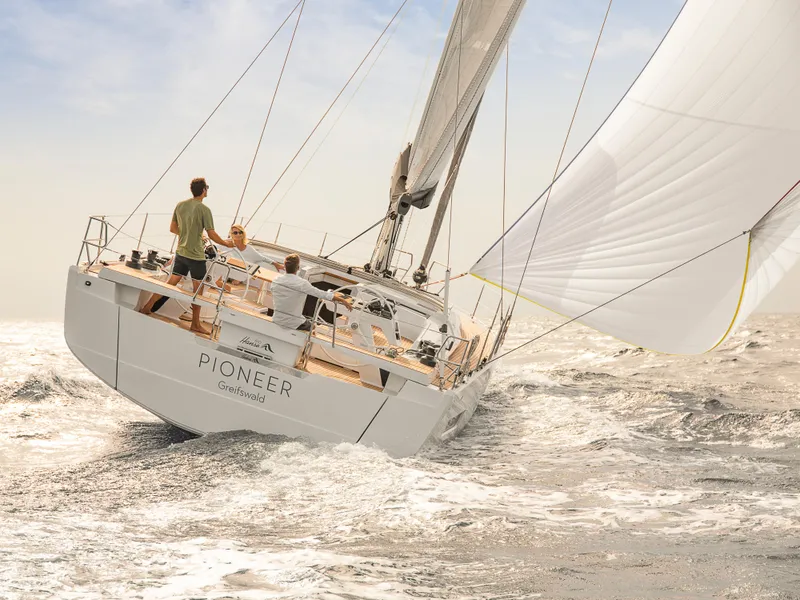 Slide: The Image of 2024 Hanse 510 sailboat navigating the ocean with full sails. - 24