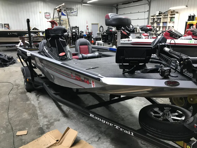 Slide: The Image of 2018 Ranger RT178 fishing boat in a garage, equipped with modern electronics and seating. - 13