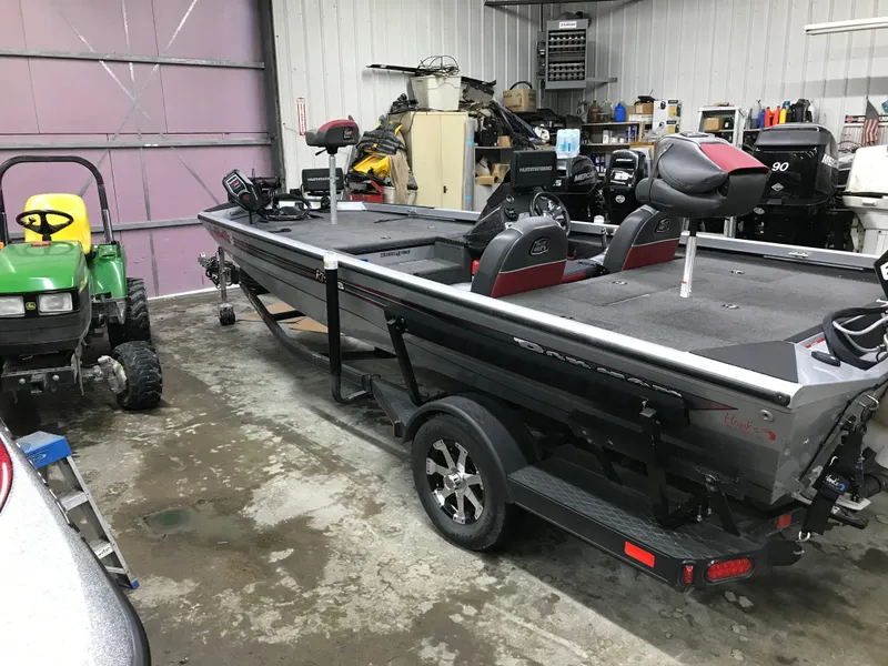 Slide: The Image of 2018 Ranger RT178 boat in a garage, alongside a green tractor. - 15