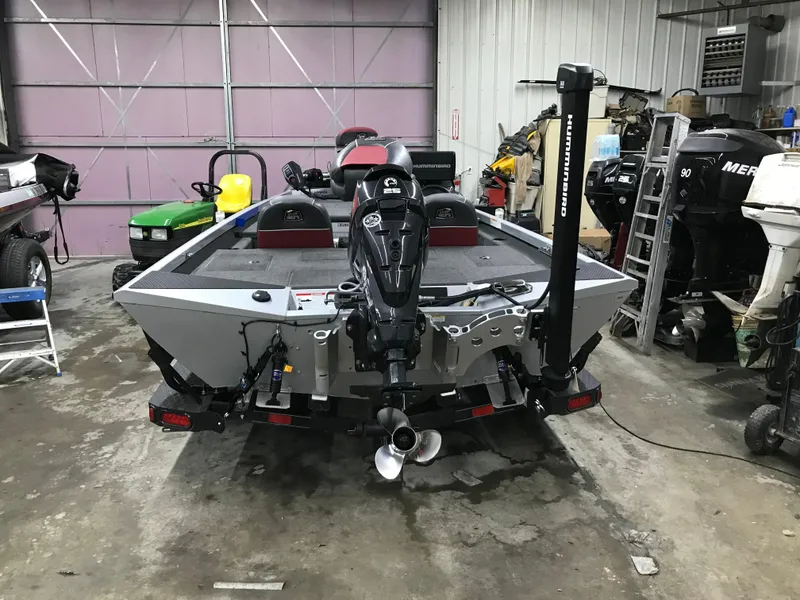 Slide: The Image of 2018 Ranger RT178 boat in a garage, featuring a powerful outboard motor. - 16
