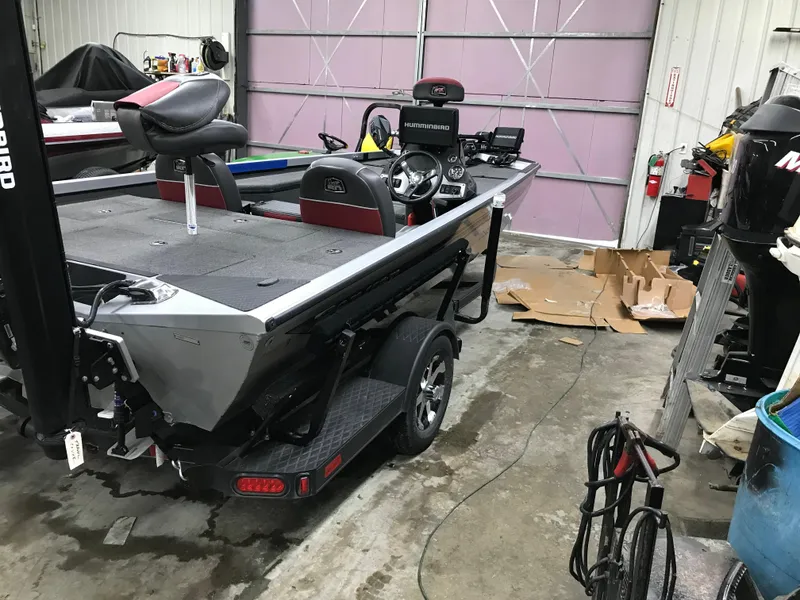 Slide: The Image of 2018 Ranger RT178 boat in a garage, featuring a sleek design and modern equipment. - 17