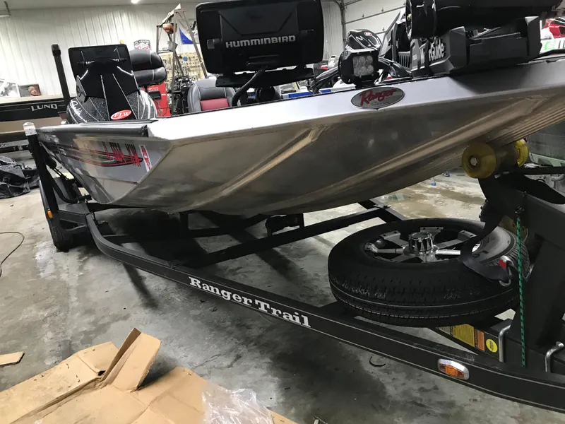 Slide: The Image of 2018 Ranger RT178 boat on trailer in garage, featuring Humminbird electronics. - 18