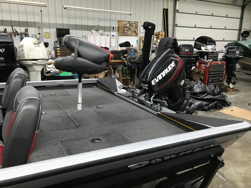 Slide: The Image of 2018 Ranger RT178 boat with Evinrude motor in a garage setting. - 23