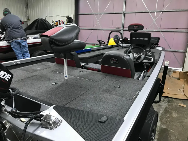 Slide: The Image of 2018 Ranger RT178 fishing boat interior with steering console and seating in a garage. - 24