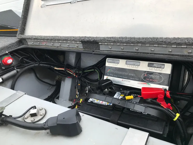 Slide: The Image of 2018 Ranger RT178 boat battery compartment with wiring and charger components. - 35