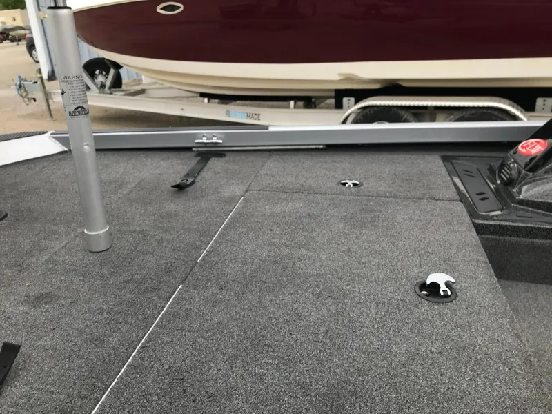 Slide: The Image of 2018 Ranger RT178 boat deck with gray carpet and storage compartments. - 36