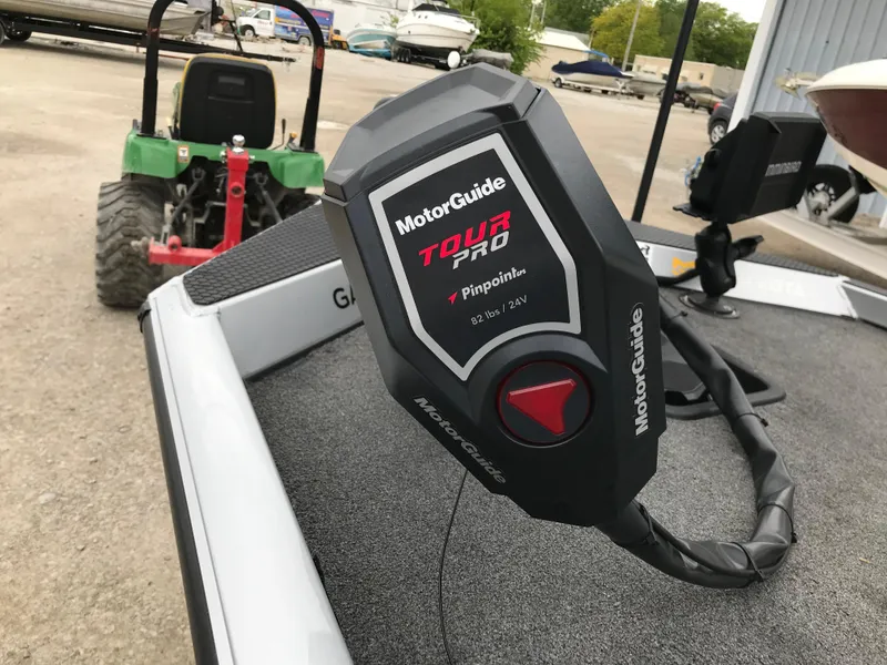 Slide: The Image of MotorGuide Tour Pro motor on 2018 Ranger RT178 boat, parked near a green tractor. - 37