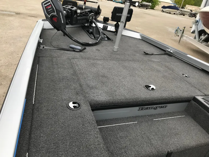 Slide: The Image of 2018 Ranger RT178 boat deck with carpeted surface and fishing equipment. - 38