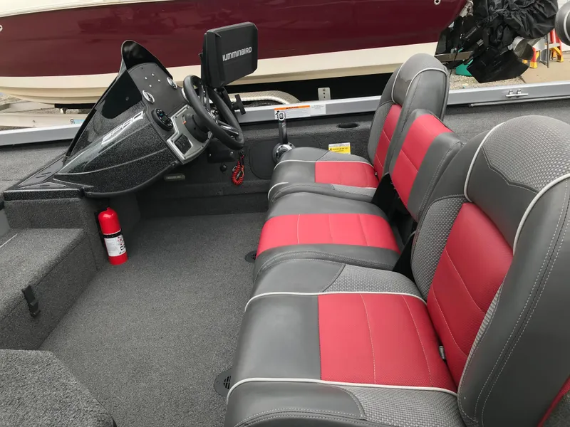 Slide: The Image of 2018 Ranger RT178 boat interior with red and gray seats, steering console, and fire extinguisher. - 39