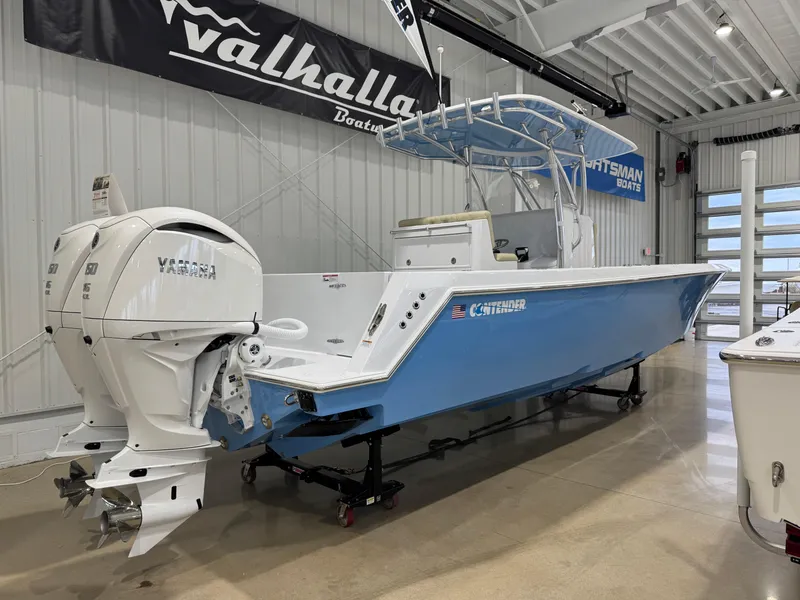 Slide: The Image of 2025 Contender 32 ST boat with twin Yamaha engines in a showroom. - 1