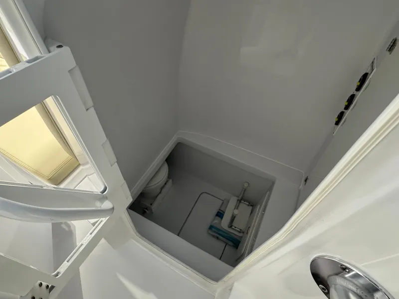 Slide: The Image of 2025 Contender 32 ST boat interior with compact bathroom and storage area. - 12
