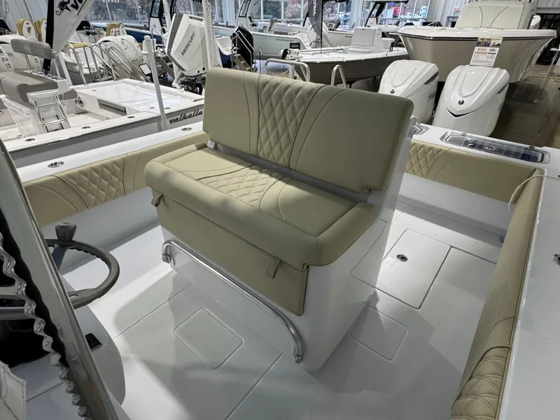 Slide: The Image of 2025 Contender 32 ST boat interior with beige seating and steering wheel. - 13