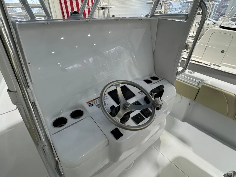 Slide: The Image of 2025 Contender 32 ST boat helm with steering wheel and control panel. - 14