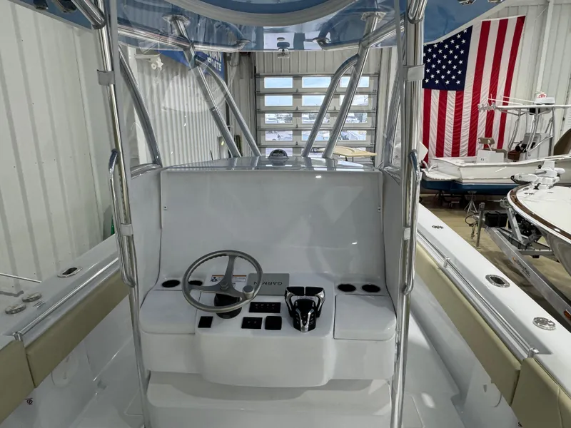 Slide: The Image of 2025 Contender 32 ST boat interior with steering console in a showroom. - 5