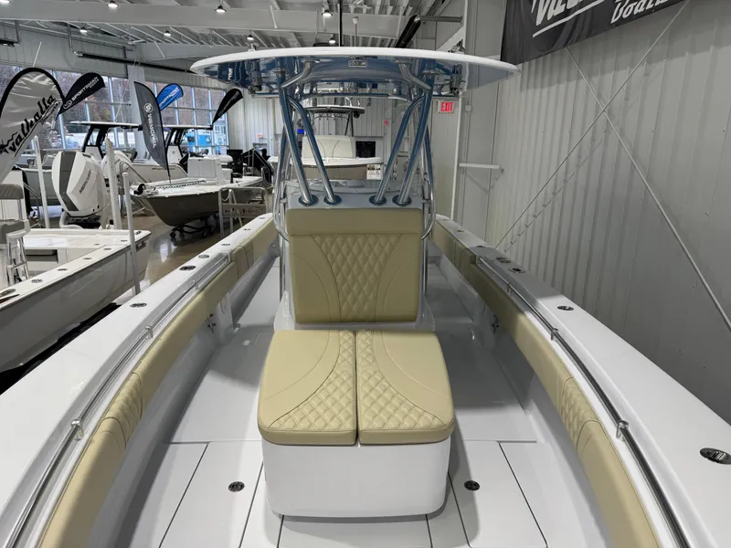 Slide: The Image of 2025 Contender 32 ST boat interior with beige seating in showroom. - 9