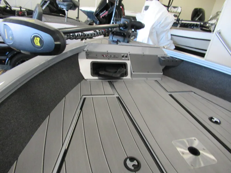 Slide: The Image of 2024 Vexus ADX 190 boat deck with storage compartments and trolling motor. - 2