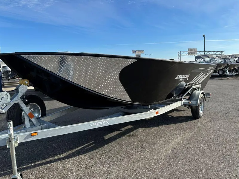 The Image of 2024 Smoker Craft 1872 PRO SPORTSMAN TL boat on a trailer in a parking lot. - 0