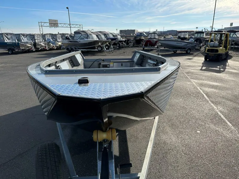 Slide: The Image of 2024 Smoker Craft 1872 PRO SPORTSMAN TL boat on trailer in a marina. - 2