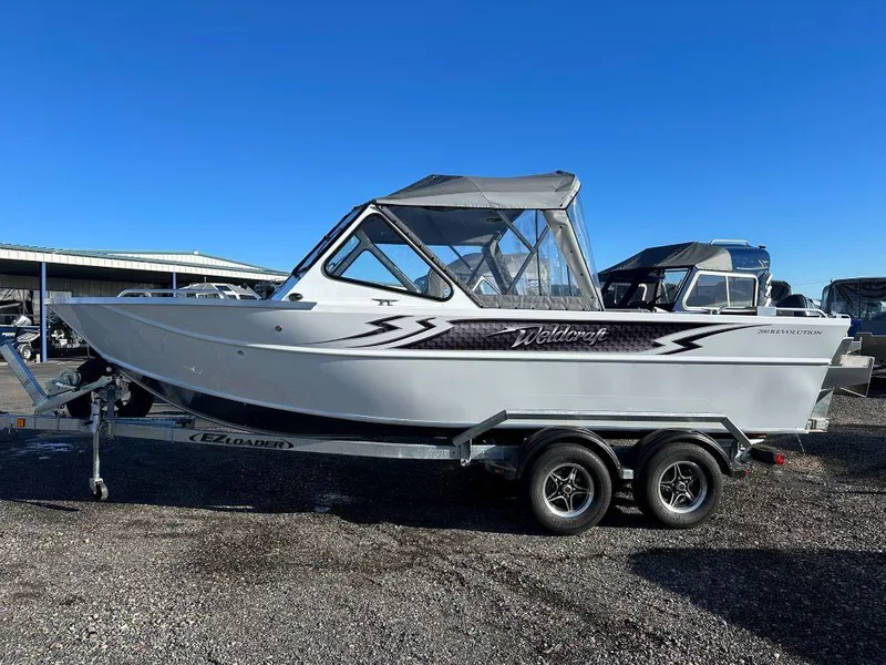 The Image of 2024 Weldcraft 200 Revolution boat on a trailer under clear blue sky. - 0