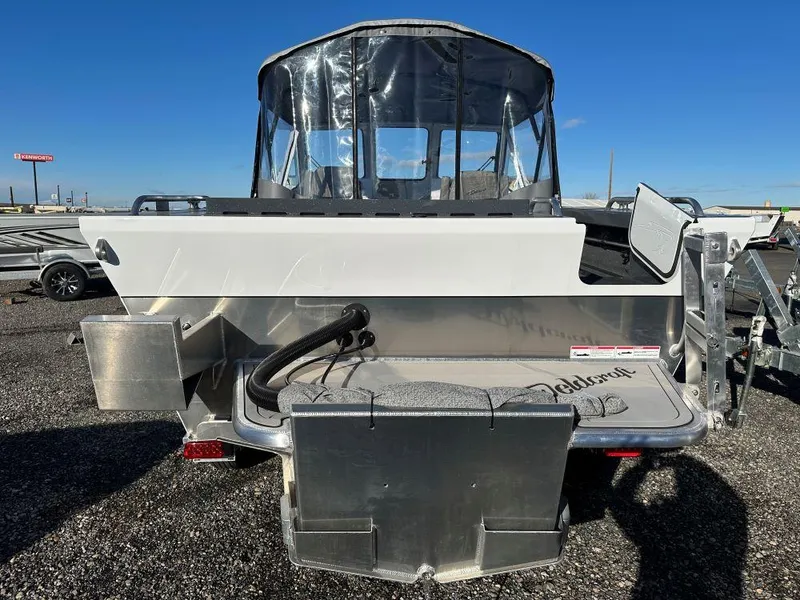Slide: The Image of 2024 Weldcraft 200 Revolution boat, rear view, parked on gravel lot. - 3