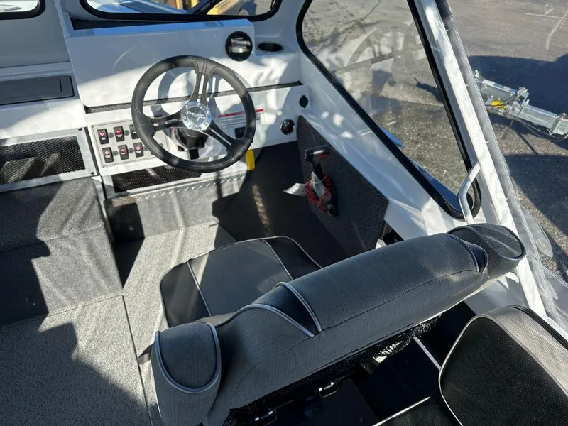 Slide: The Image of 2024 Weldcraft 200 Revolution boat interior with steering wheel and seating. - 6
