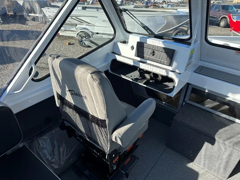 Slide: The Image of 2024 Weldcraft 200 Revolution boat interior with captain's chair and dashboard. - 7