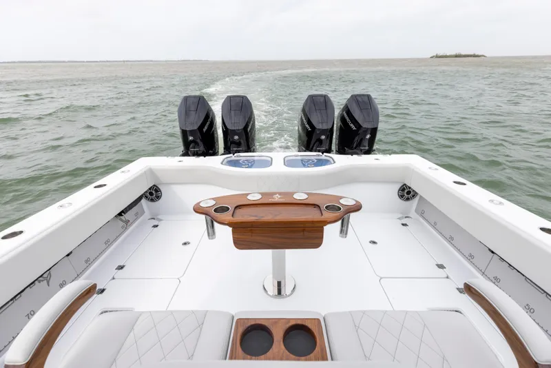 Slide: The Image of 2024 Freeman 42 LR boat with quad outboard engines on open water. - 19