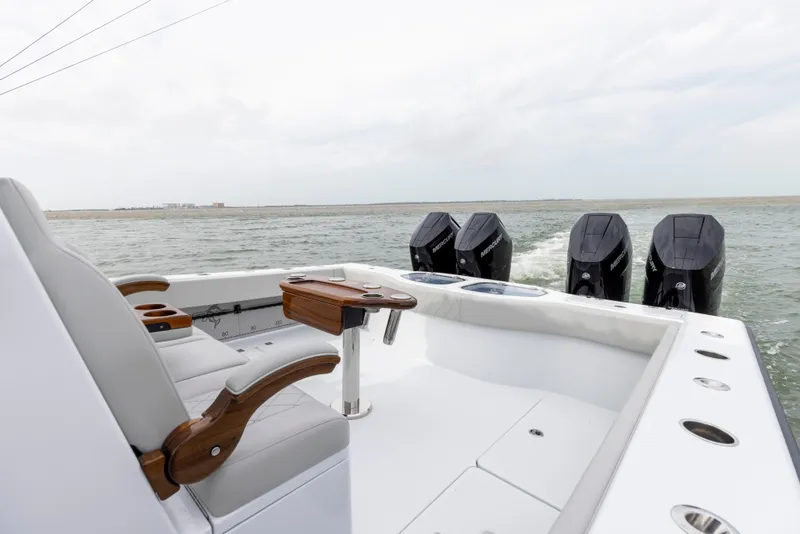 Slide: The Image of 2024 Freeman 42 LR boat with four outboard motors on open water. - 20