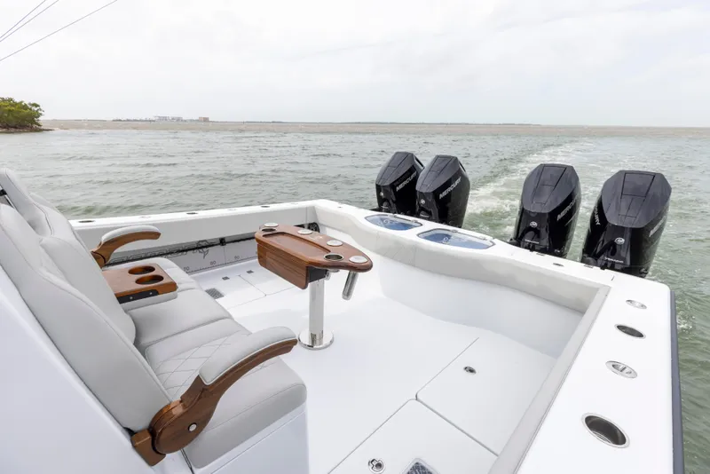 Slide: The Image of 2024 Freeman 42 LR boat with quad outboard motors on open water. - 21