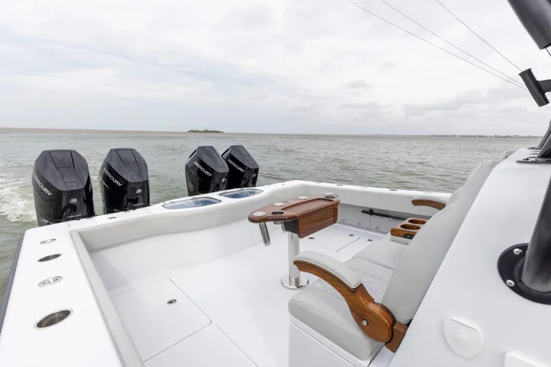 Slide: The Image of 2024 Freeman 42 LR boat with quad outboard engines on open water. - 22