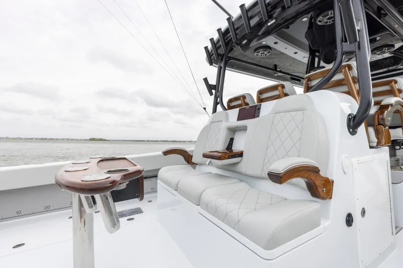 Slide: The Image of 2024 Freeman 42 LR boat with luxurious seating and fishing rod holders. - 23