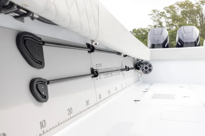 Slide: The Image of 2024 Freeman 42 LR boat interior with rod holders and measuring scale. - 25