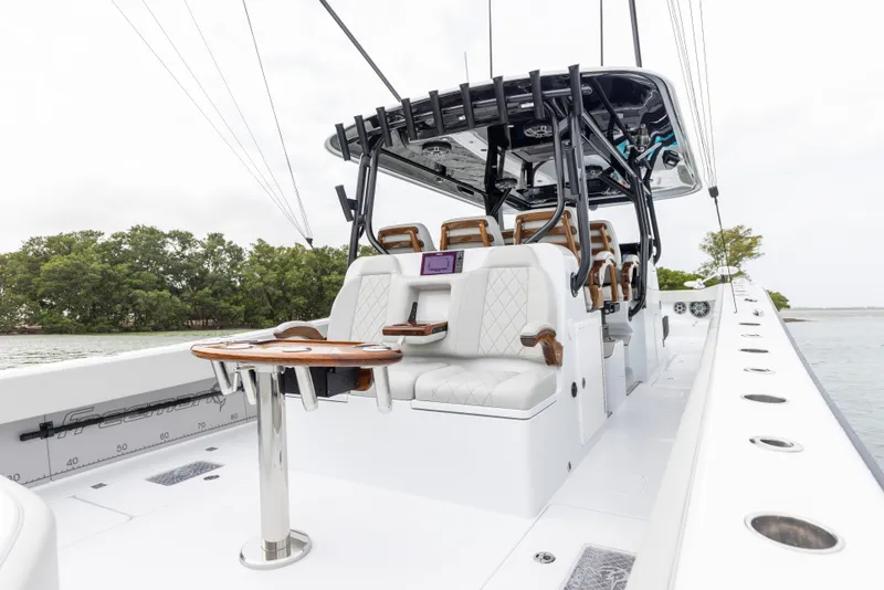 Slide: The Image of 2024 Freeman 42 LR boat interior with white seating and wooden table. - 27
