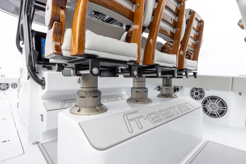 Slide: The Image of Freeman 42 LR 2024 boat with cushioned wooden seats and branded deck. - 29