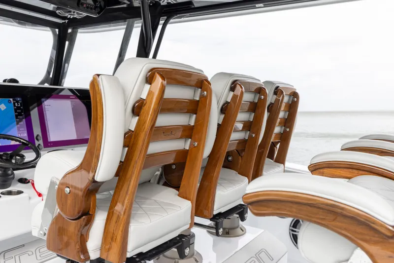 Slide: The Image of Luxurious seating on the 2024 Freeman 42 LR boat with wooden accents and white upholstery. - 31