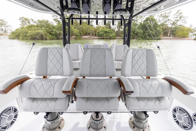 Slide: The Image of Luxurious seating on the 2024 Freeman 42 LR boat with scenic water backdrop. - 36