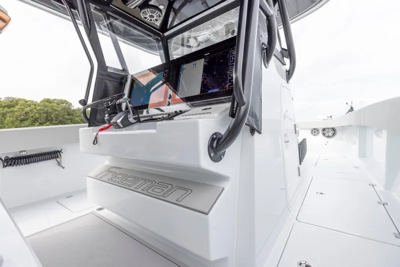 Slide: The Image of 2024 Freeman 42 LR boat cockpit with advanced navigation system. - 38