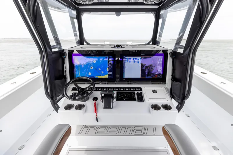 Slide: The Image of 2024 Freeman 42 LR boat cockpit with advanced navigation system and dual screens. - 40