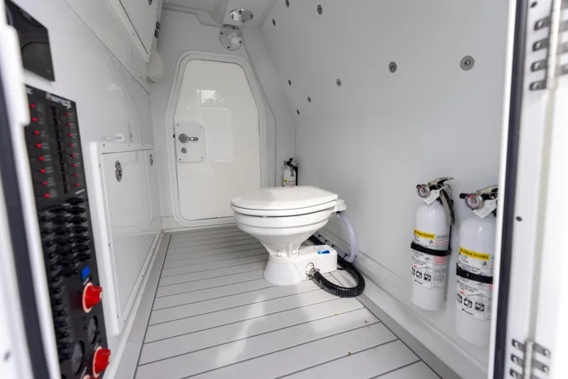 Slide: The Image of 2024 Freeman 42 LR boat interior with toilet and fire extinguishers. - 48