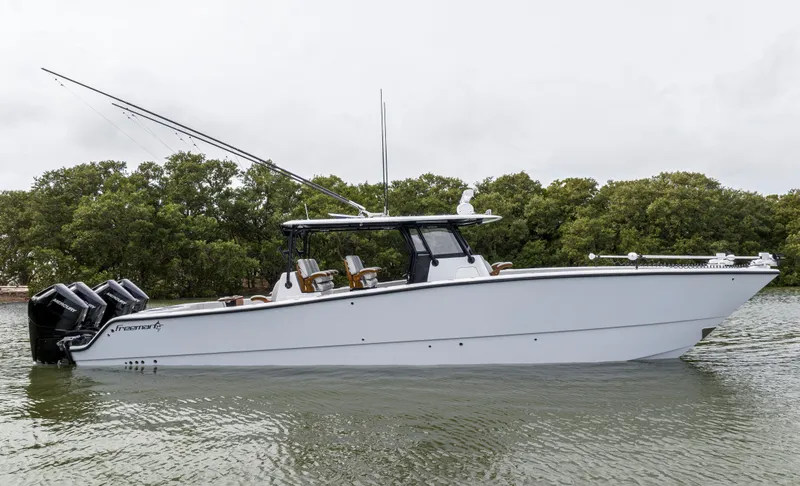 Slide: The Image of 2024 Freeman 42 LR boat on water with trees in background. - 6