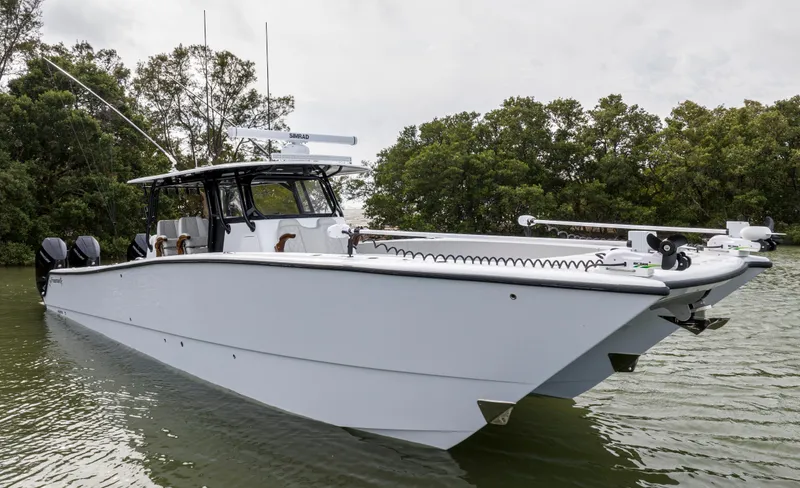 Slide: The Image of 2024 Freeman 42 LR boat on water, side view with trees in background. - 9