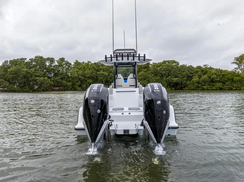 Slide: The Image of 2024 Freeman 28 boat with dual outboard engines on the water. - 14
