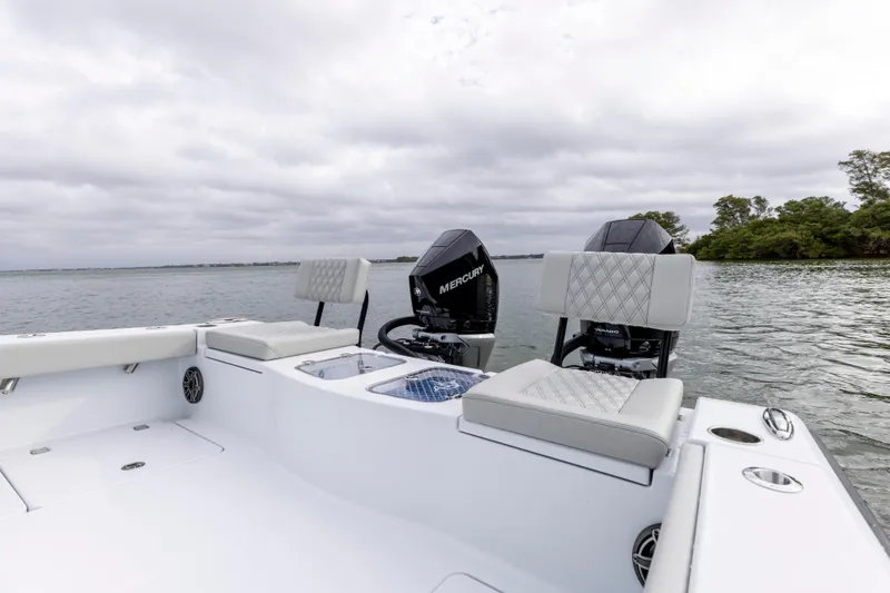 Slide: The Image of 2024 Freeman 28 boat with Mercury engines on a calm lake. - 16