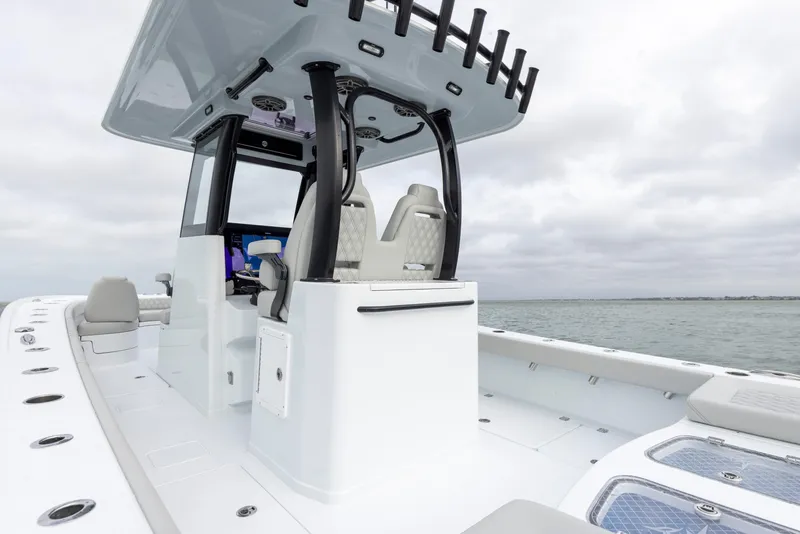 Slide: The Image of 2024 Freeman 28 boat with modern console and seating on open water. - 19